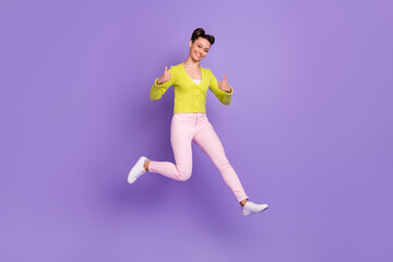 Fototapeta na wymiar Full length body size photo of woman with girlish hairstyle jumping high showing thumb-up sign isolated on pastel violet color background