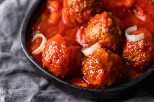 Close view of Frying pan  with homemade Meatballs in tomato sauce .