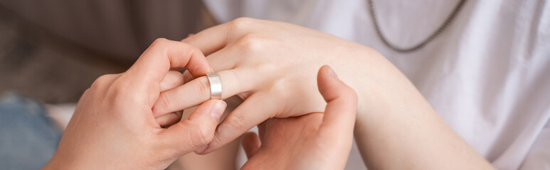 cropped view of woman wearing ring on finger of girlfriend, banner
