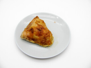 baked chicken thigh on a gray plate on a white background