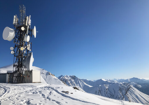 Winter view of transmitters on a sunny day, around the traces of people, on Mount Georgia Gudauri