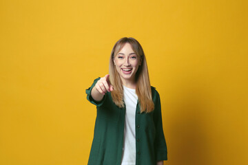 Beautiful young woman laughing on yellow background. Funny joke