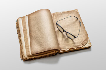 Glasses on the yellowed pages of an old book