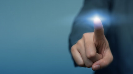 Businessman pressing button on virtual screen. business man hand draws gear to success, can put your text at the finger, copy space.