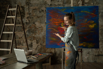 Female artist draws a picture and conducts a remote drawing training class. Woman shows that she draws, and teaches her students