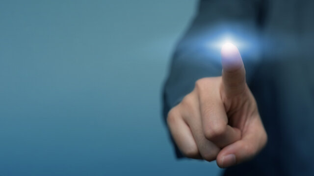 Businessman pressing button on virtual screen. business man hand draws gear to success, can put your text at the finger, copy space. - Powered by Adobe