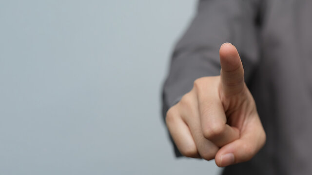 Businessman pressing button on virtual screen. business man hand draws gear to success, can put your text at the finger, copy space.