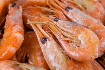 Cooked unpeeled shrimp and prawns, close-up. Seafood of the order of crustaceans