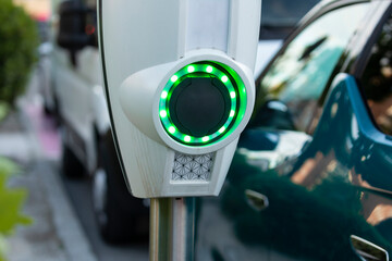 A battery charging point for electric cars, illuminated with green LEDs, in the area of the Retiro...