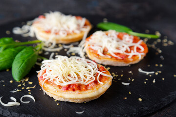 Mini pizzas with sausages and cheese - obrazy, fototapety, plakaty