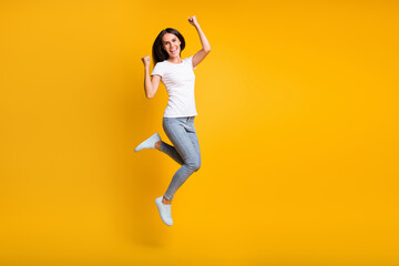 Fototapeta na wymiar Full body photo of happy charming young lady jump up air luck winner isolated ob yellow color background