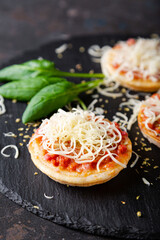 Mini pizzas with sausages and cheese