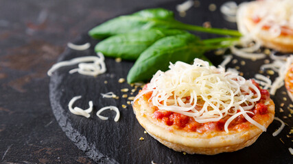 Mini pizzas with sausages and cheese