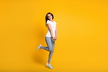 Fototapeta na wymiar Full body photo of charming nice young woman adorable pose isolated on shine yellow color background