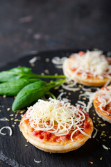 Mini pizzas with sausages and cheese