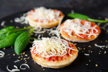 Mini pizzas with sausages and cheese