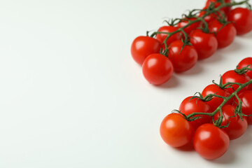 Fresh cherry tomato branches on white background