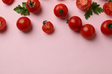 Fresh cherry tomato on pink background, space for text