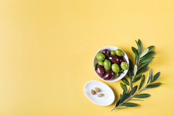 Fresh olives and olive tree branch on a table