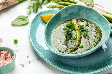 Cream soup with asparagus. Healthy vegetable soup. Vegan food. Flat lay. Banner. Top view