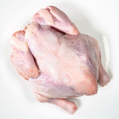 whole air chilled uncooked chicken on white plate