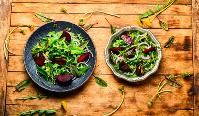 Spring greens and beetroot salad,wooden table