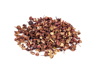 handful of dried pink sichuan pepper on white
