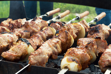 Marinated shashlik preparing on a barbecue grill over charcoal. Selective focus. Shashlyk (skewered meat) was originally made of lamb. Roast Beef Kebabs On BBQ Grill.