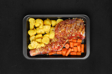 Marinated lamb shoulder with potato and carrot in oven-tray