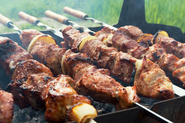 Marinated shashlik preparing on a barbecue grill over charcoal. Shashlik or Shish kebab popular in Eastern Europe. Shashlyk (skewered meat) was originally made of lamb. Roast Beef Kebabs On BBQ Grill.