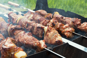 Marinated shashlik preparing on a barbecue grill over charcoal. Shashlik or Shish kebab popular in Eastern Europe. Shashlyk (skewered meat) was originally made of lamb. Roast Beef Kebabs On BBQ Grill.