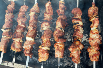 Marinated shashlik preparing on a barbecue grill over charcoal. Shashlik or Shish kebab popular in Eastern Europe. Shashlyk (skewered meat) was originally made of lamb. Roast Beef Kebabs On BBQ Grill.