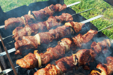 Marinated shashlik preparing on a barbecue grill over charcoal. Shashlik or Shish kebab popular in Eastern Europe. Shashlyk (skewered meat) was originally made of lamb. Roast Beef Kebabs On BBQ Grill.