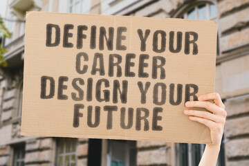 The phrase " Define your career. Design your future " on a banner in men's hand with blurred background. Education. Success. Study. College. University. Knowledge