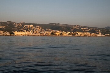 Lebanon city of Batroun viewed from the sea in a distance