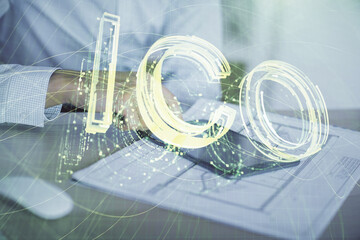 Double exposure of man's hands holding and using a phone and crypto currency blockchain theme...
