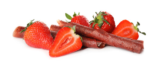 Delicious fruit leather rolls and strawberries on white background