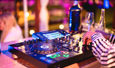 Dj playing music at cocktail bar outdoor at night time - Entertainment and party concept - Focus on...