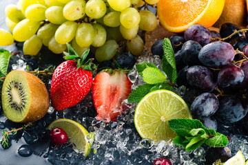Fresh fruits background. Slices of fresh fruits on ice.