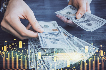 Multi exposure of technology drawing hologram and us dollars bills and man hands. Data concept