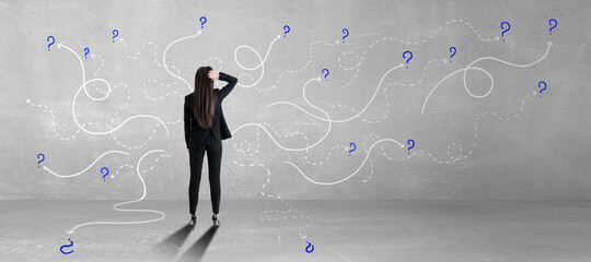 Answer for the questions concept with businesswoman in front of concrete wall with white curved lines and question marks.