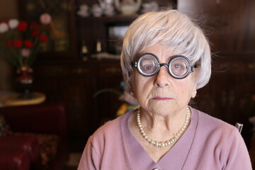 Senior humorous woman with old fashioned eyeglasses

