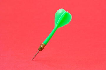 Green dart arrow on the red background