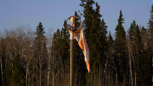 Broken Windbag With Spruce Forest In Background At Fort St. James Airport In British Columbia, Canada. - Medium Shot