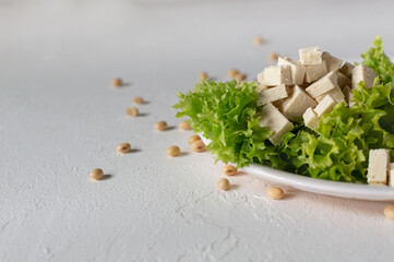 Fresh tofu (tahu) cheese with Natural organic soy beans on white background. Close-up