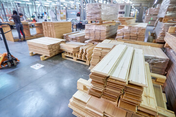 Carpentry factory. Modernized woodworking manufacture. Robotic equipment composing wooden panels inside the parquet floor factory.