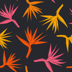 seamless pattern with tropical exotic flower bird of paradise in orange yellow, red colors on black background
