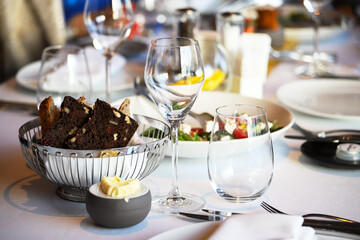 Glassware, glasses for white wine on a table in the restaurant. Banquet, cutlery, table setting. 