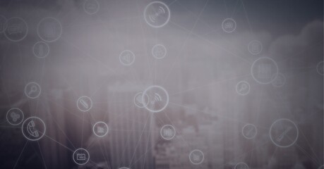 Network of digital icons over cityscape against grey background