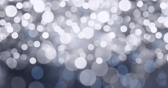 Digital generated image of spots of bokeh lights against grey background
